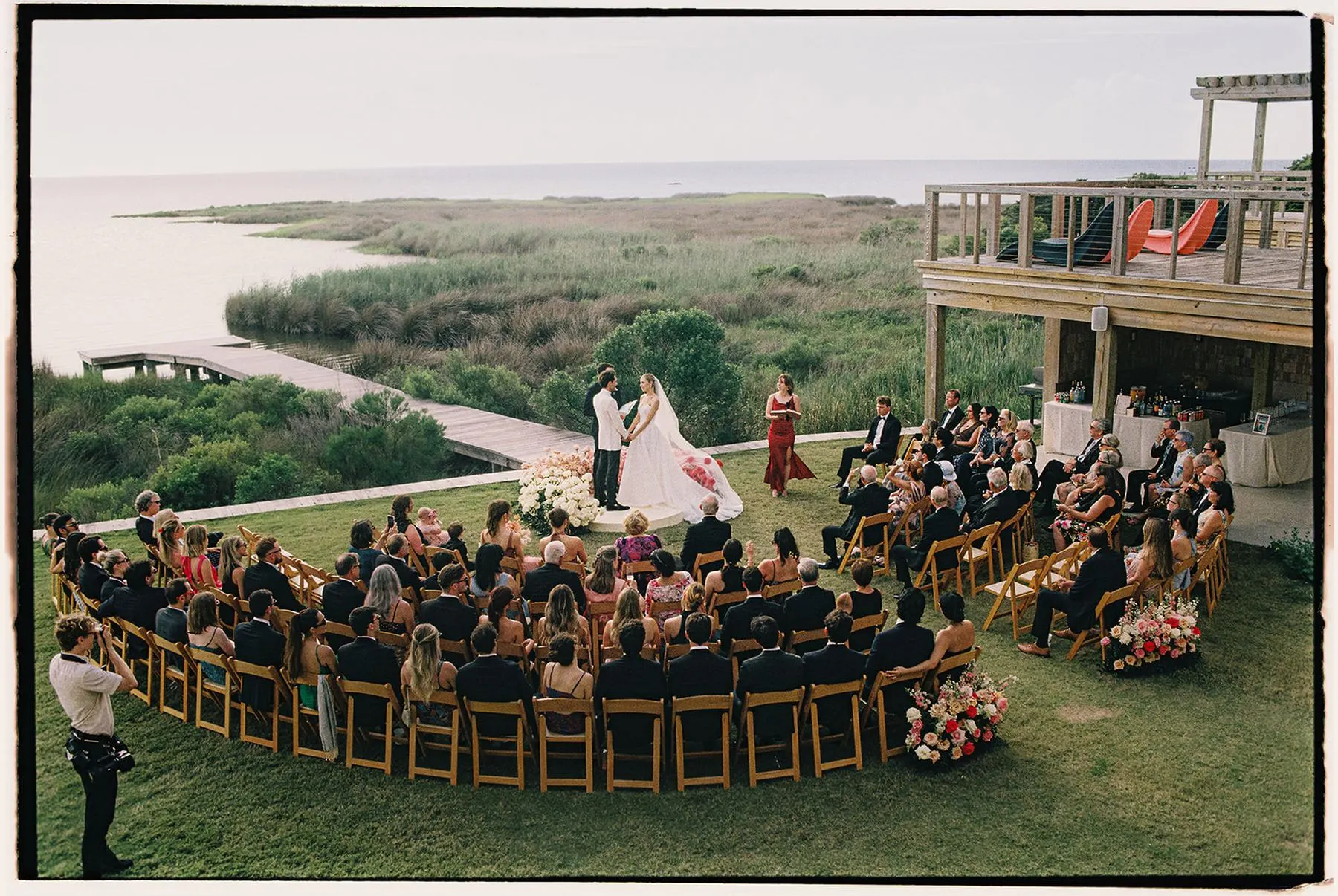 Ceremony on the Edgecamp lawn above the sea grass and sound